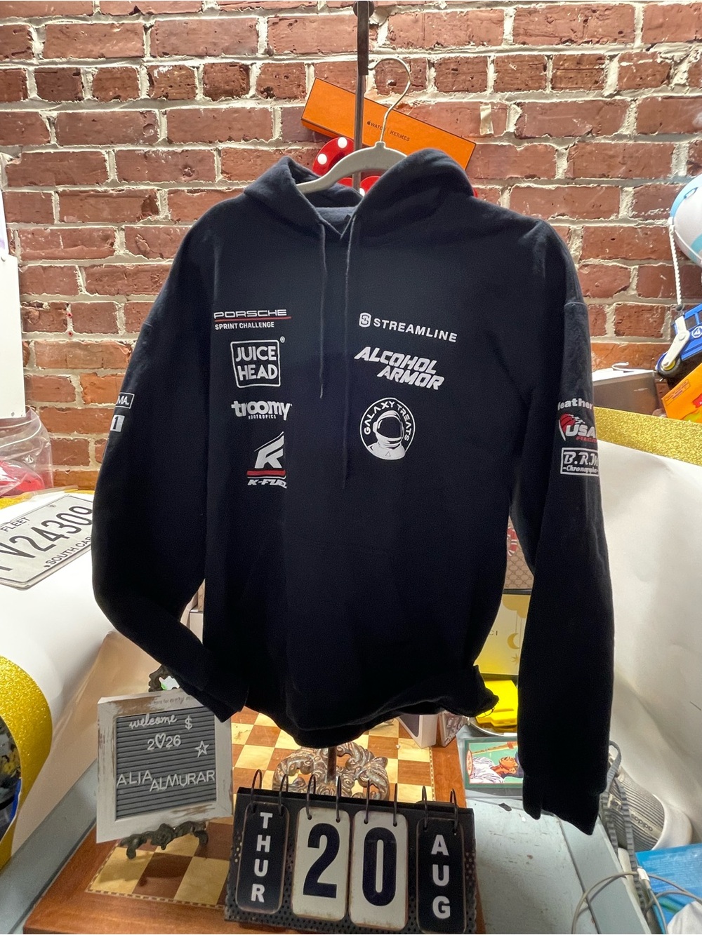 motorsport-style pullover hoodie featuring various sponsor and brand logos